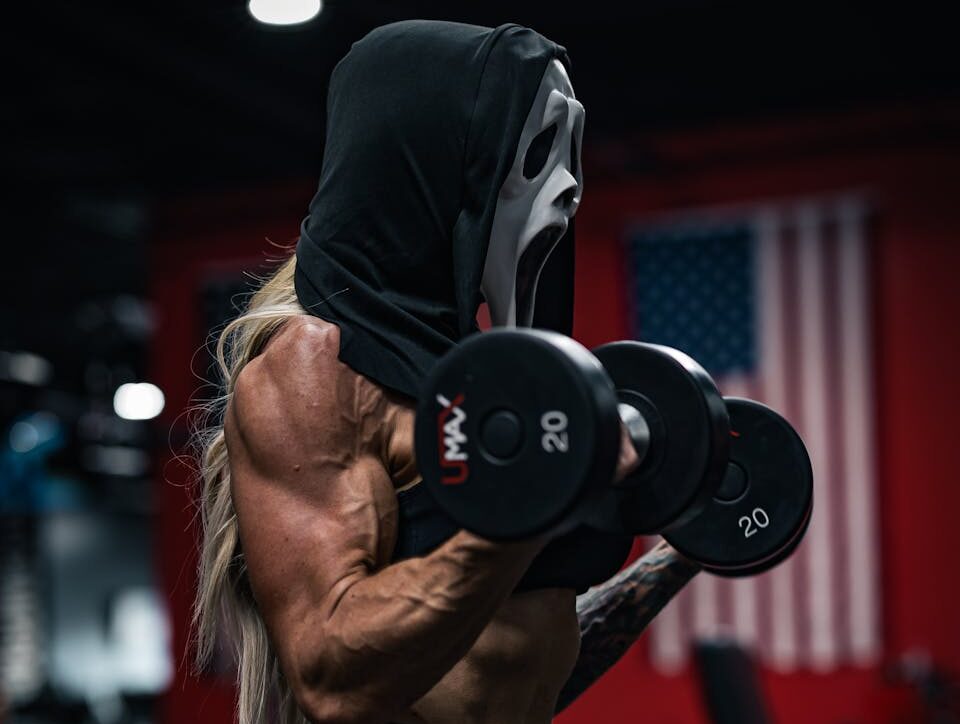 Woman in a Halloween Mask Exercising at the Gym