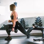 woman in black sports bra and black leggings doing exercise