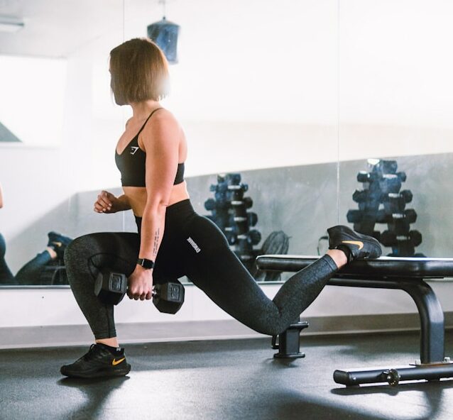 woman in black sports bra and black leggings doing exercise